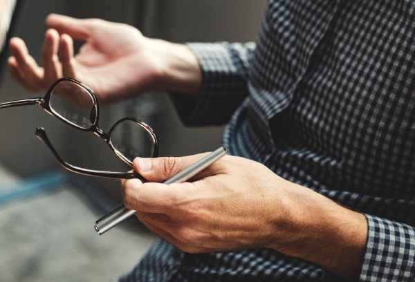 person holding eyeglasses